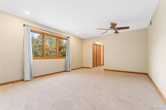 a view of room with a ceiling fan and window