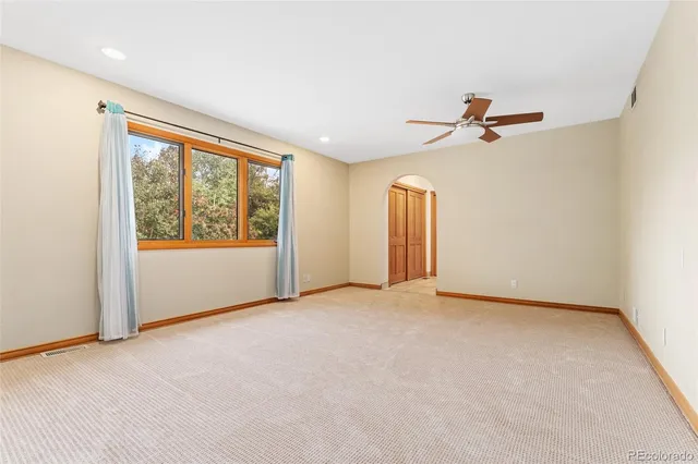 a view of room with a ceiling fan and window