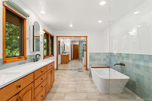a large spacious bathroom with a large tub and shower