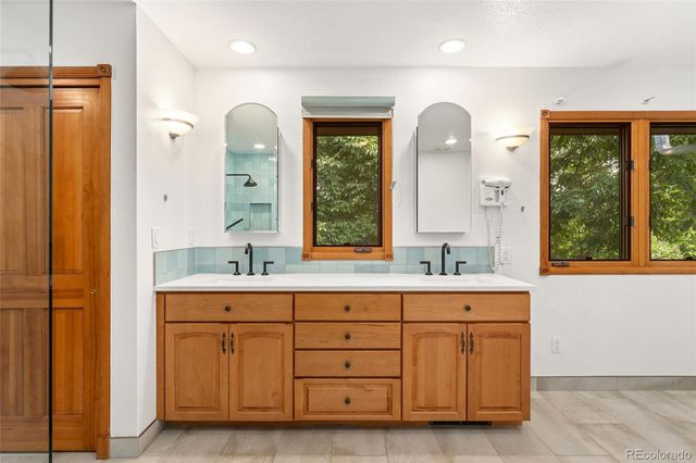 a bathroom with a double vanity sink and a large mirror