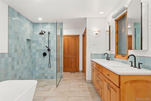 a bathroom with a double sink shower and a mirror