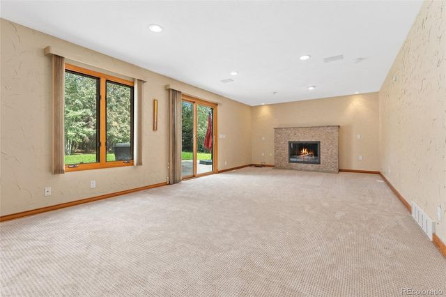 a view of empty room with a fireplace