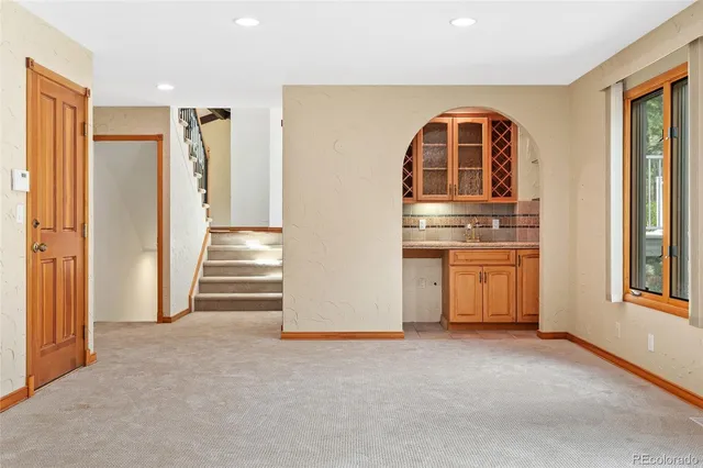 a bathroom with a sink and mirror with toilet