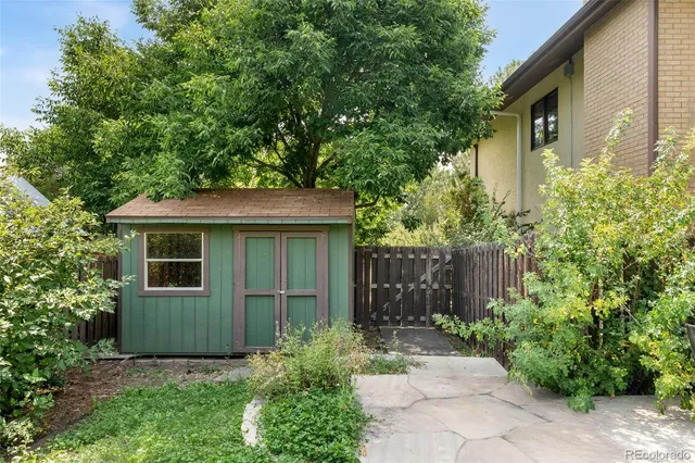 an aerial view of a house with garden space and a street view