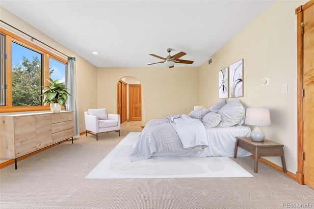 a bedroom with a bed and a large window