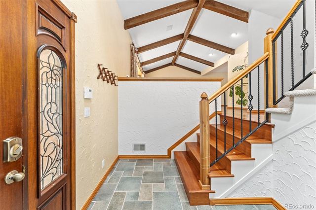a view of an entryway with wooden floor