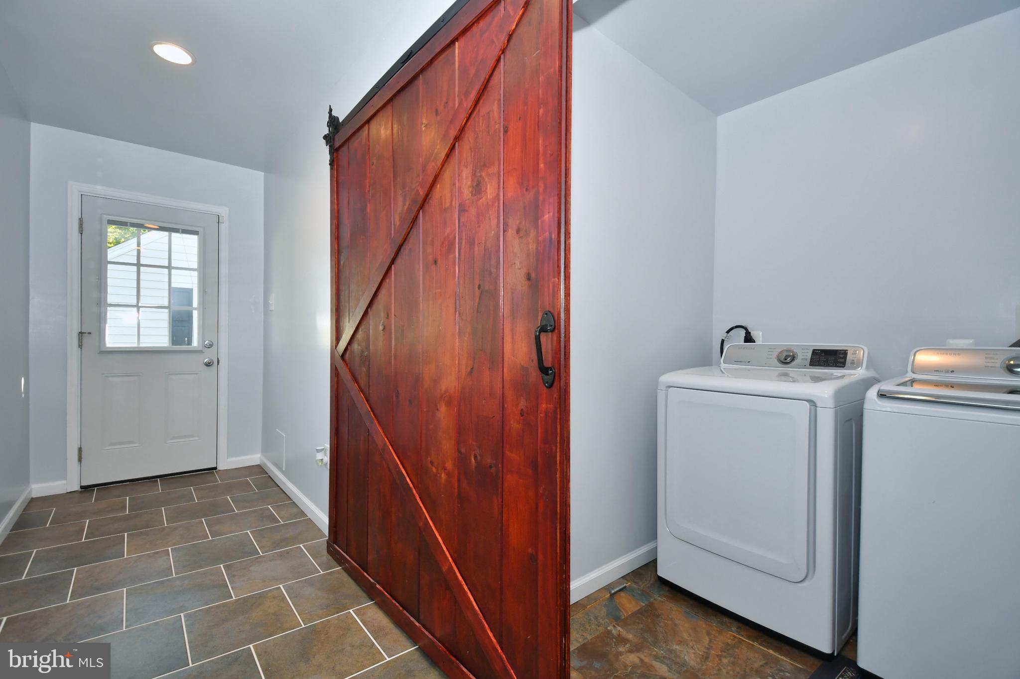 831 Martin Road Baltimore, MD 21221 - Photo 16 of 28 First Floor Laundry with Barn Door