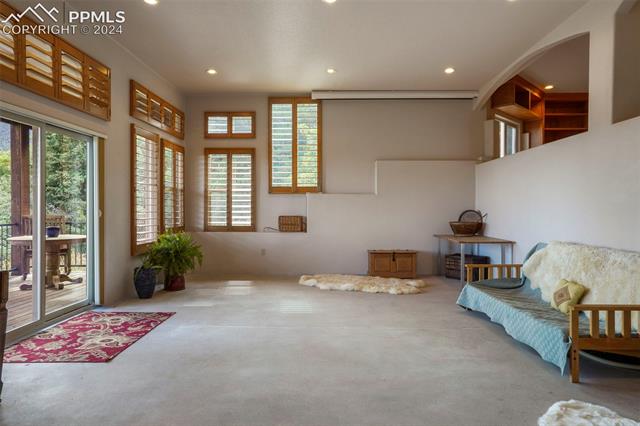 915 Oak Ridge Road Manitou Springs, CO 80829 - Photo 28 of 50 Spaciou Family Room with drop-down Entertainment Screen & Projector, heated concrete floors
