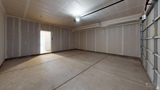 783 Pheasantbrook Drive, Unit 2A Centerville, UT 84014 - Photo 39 of 41 Spacious garage with concrete flooring, automatic garage door opener, and unfinished gypsum board walls