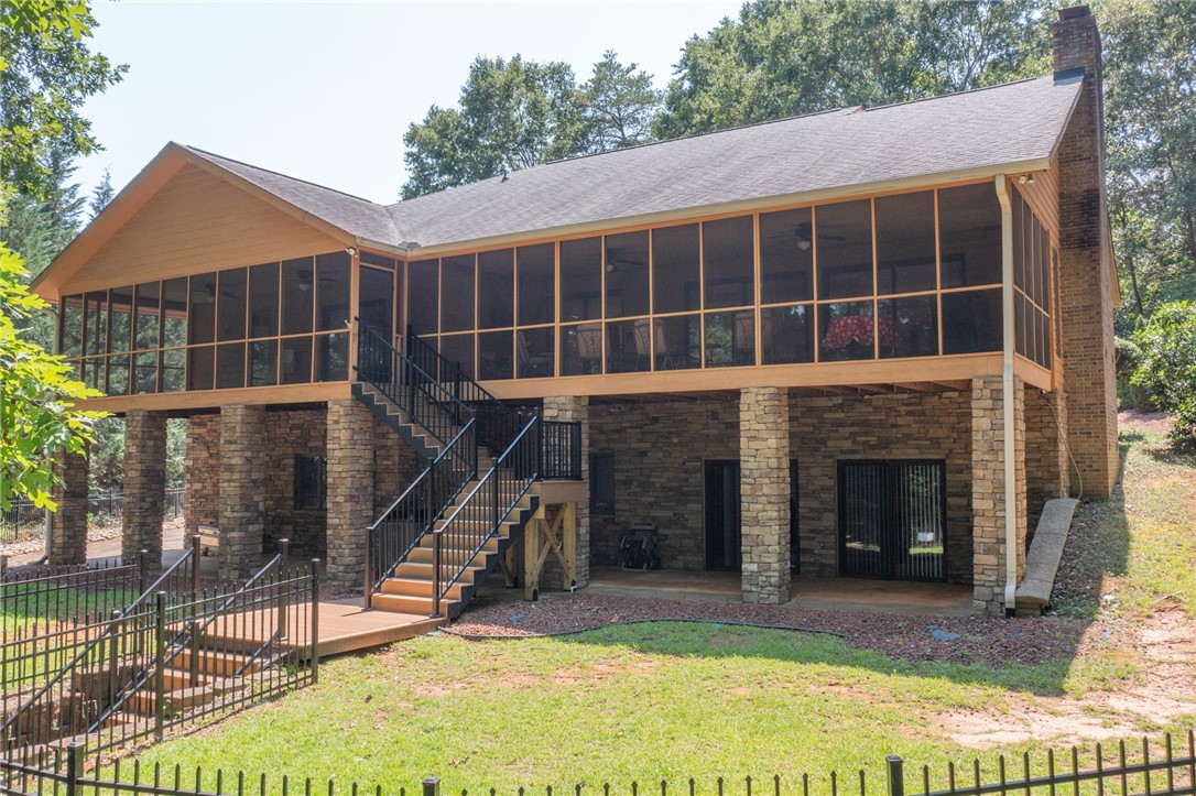 202 Plantation Point Anderson, SC 29625 - Photo 2 of 48 A spacious elevated deck, ideal for outdoor living, offers privacy and natural light.