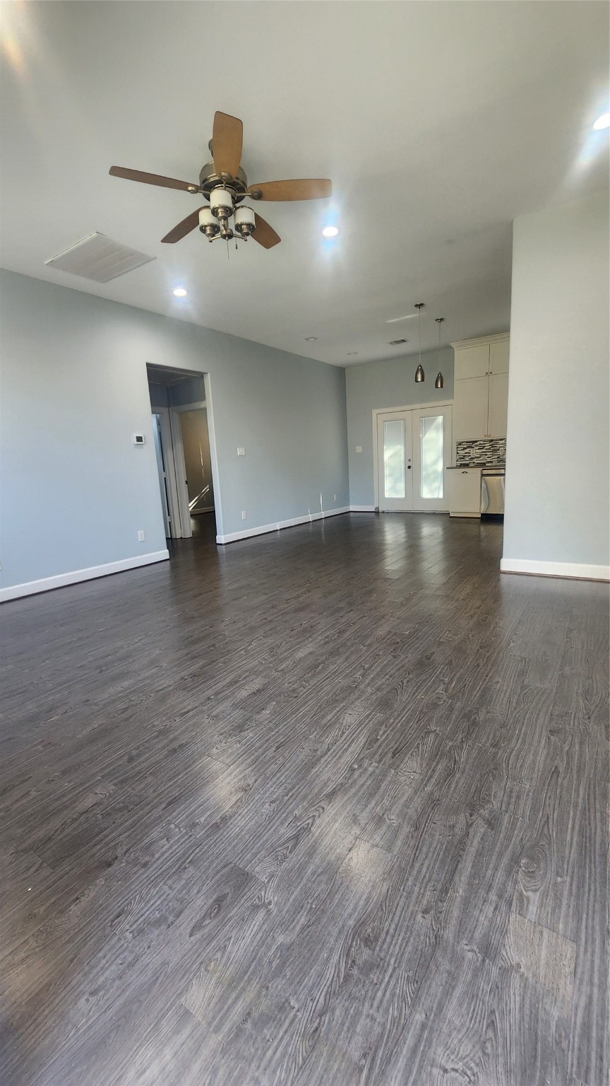 7828 Pardee Street Houston, TX 77028 - Photo 4 of 18 an empty room with wooden floor and ceiling fan