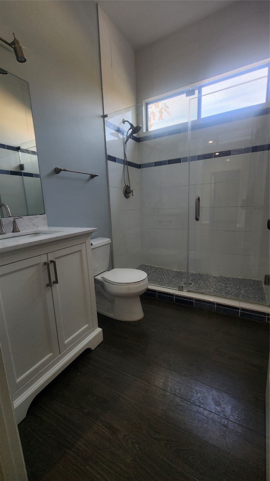 7828 Pardee Street Houston, TX 77028 - Photo 6 of 18 a bathroom with a toilet a sink and mirror