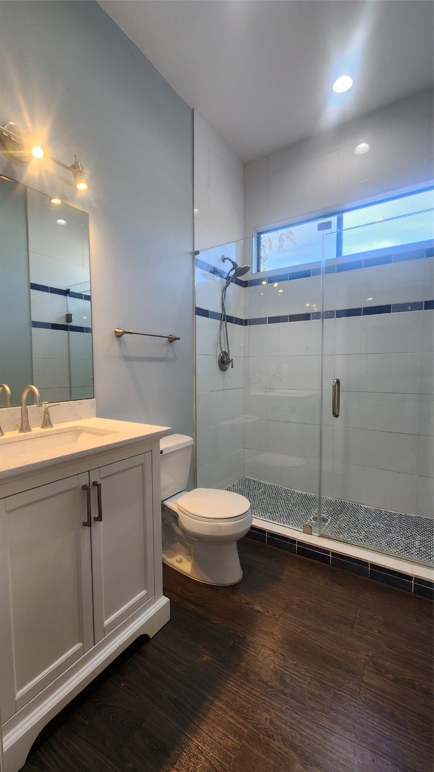 7828 Pardee Street Houston, TX 77028 - Photo 7 of 18 a bathroom with a sink a toilet and a mirror