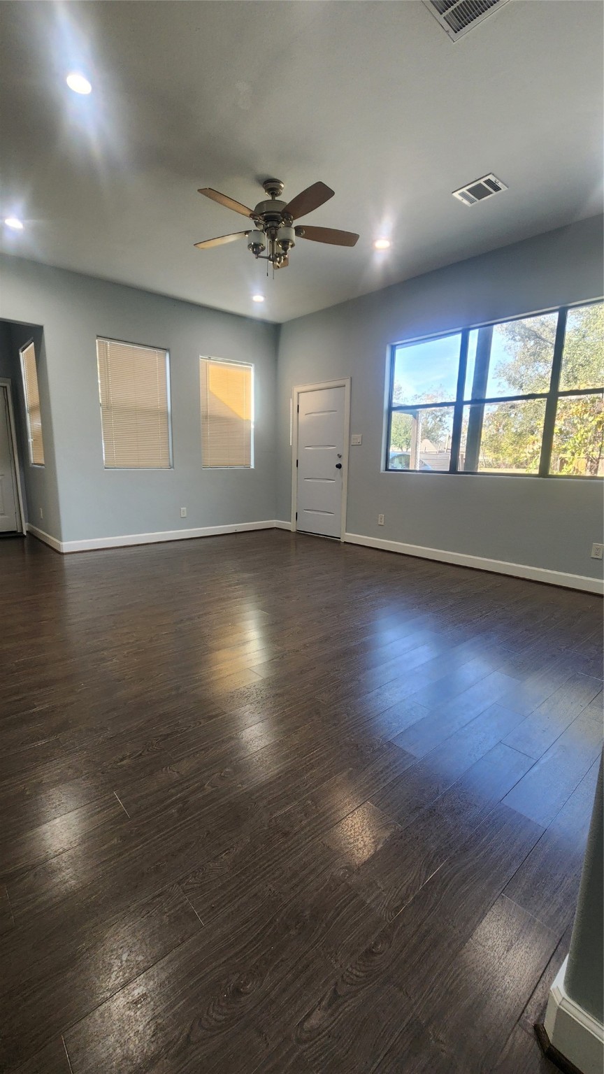 7828 Pardee Street Houston, TX 77028 - Photo 9 of 18 an empty room with wooden floor and windows