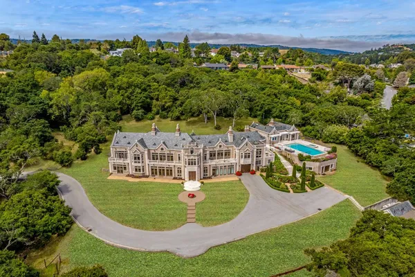 an aerial view of a house with a yard