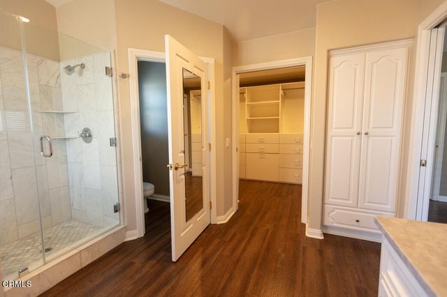 a bathroom with a shower and a glass door