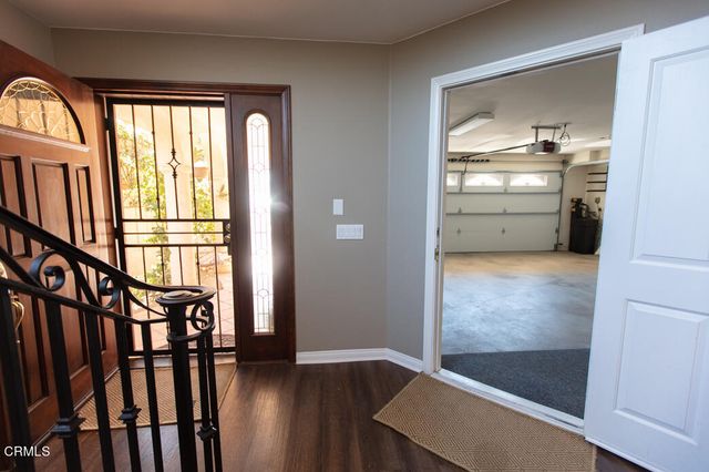 a view of an entryway with wooden floor