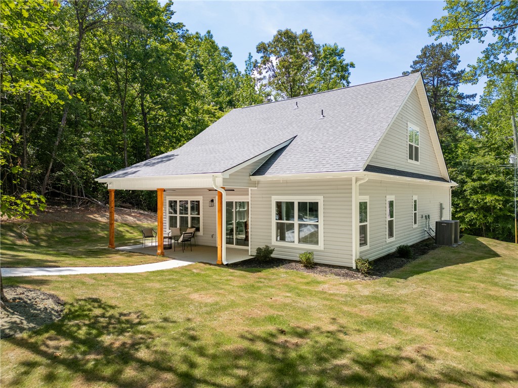 502 Point Road Westminster, SC 29693 - Photo 31 of 45 A well-maintained side yard and a covered patio create an inviting outdoor living space.