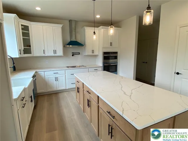 a kitchen with a sink a stove a refrigerator and cabinets