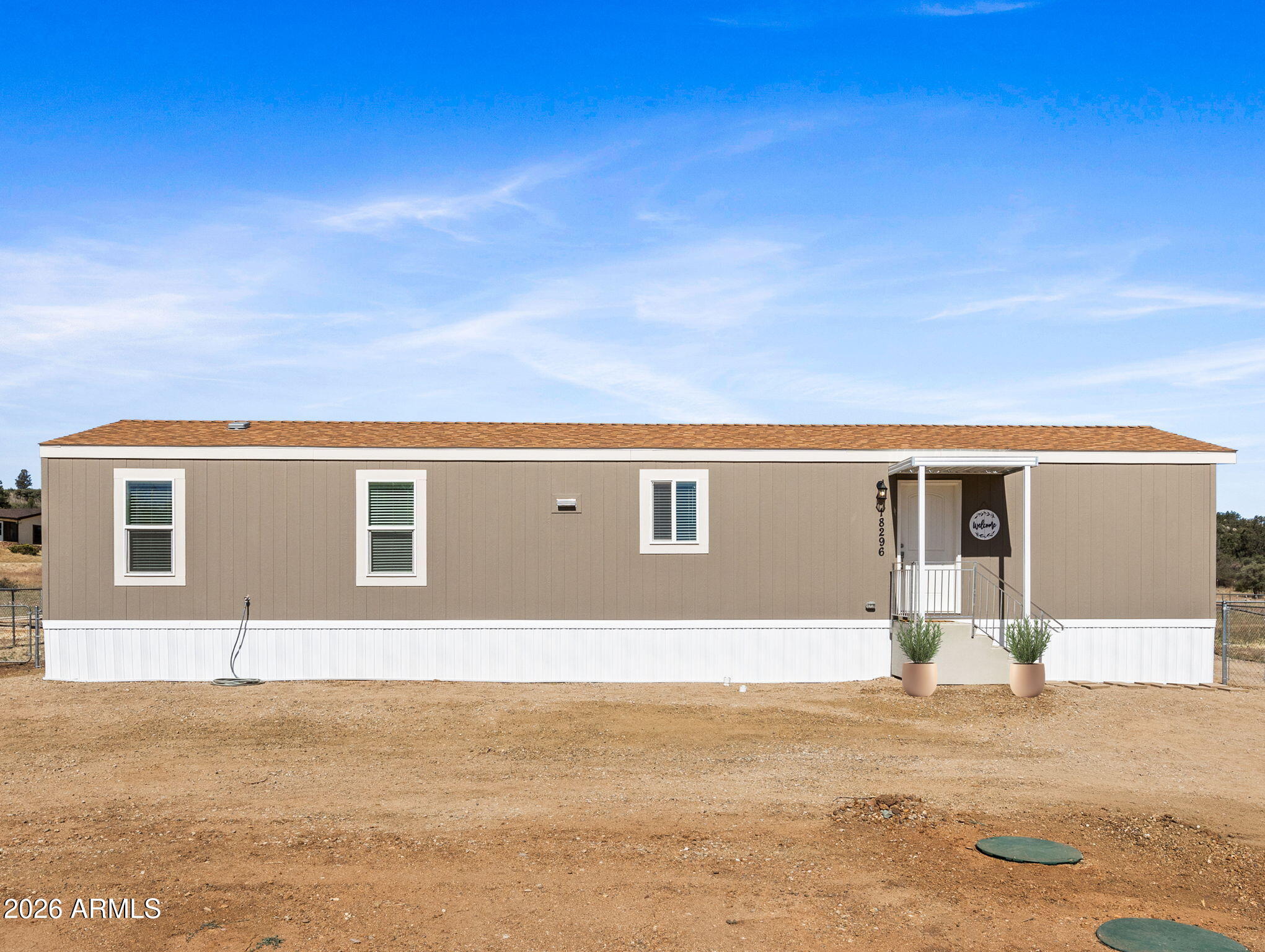 18296 Frontier Road Peeples Valley, AZ 86332 - Photo 2 of 44 a front view of a house with a yard
