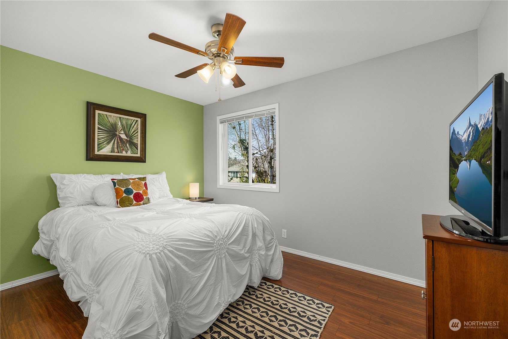 1526 192nd Street Southeast, Unit S2 Bothell, WA 98012 - Photo 14 of 16 a bedroom with a bed and a flat screen tv