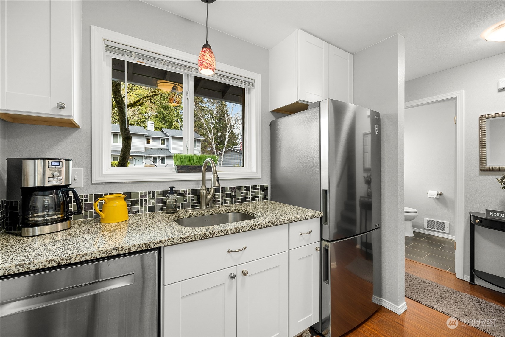 1526 192nd Street Southeast, Unit S2 Bothell, WA 98012 - Photo 5 of 16 a kitchen with stainless steel appliances granite countertop a refrigerator and a sink