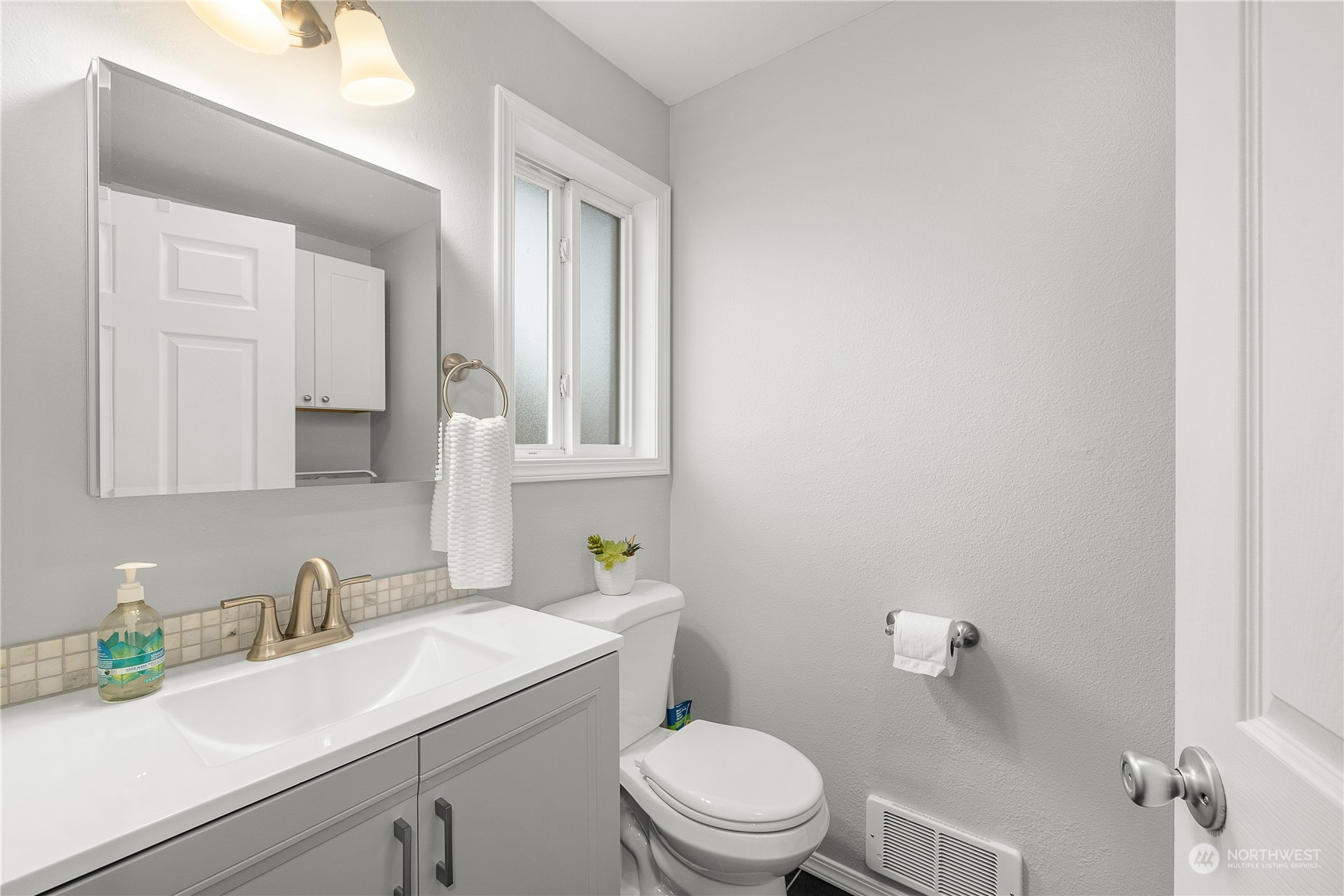 1526 192nd Street Southeast, Unit S2 Bothell, WA 98012 - Photo 6 of 16 a bathroom with a sink a toilet and a mirror