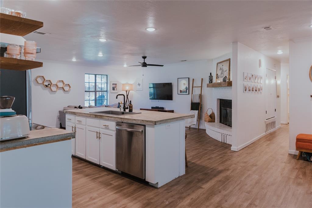 312 Perkins Road Krugerville, TX 76227 - Photo 11 of 32 a kitchen with stainless steel appliances granite countertop a sink stove and a refrigerator