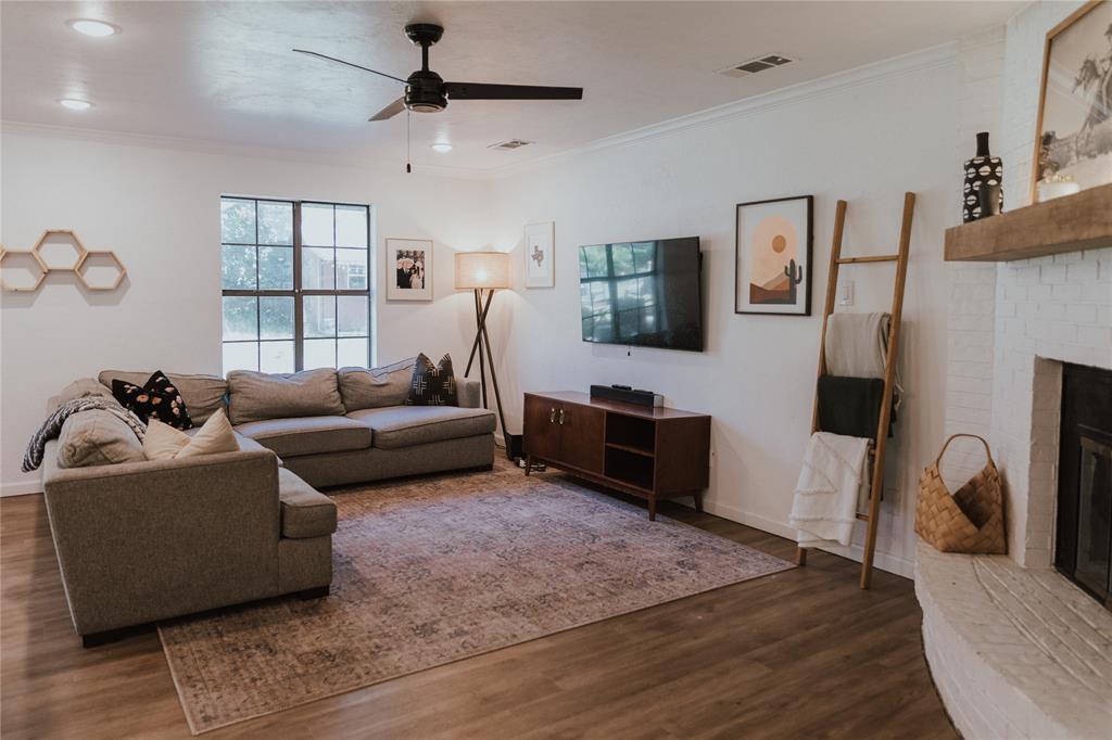 312 Perkins Road Krugerville, TX 76227 - Photo 12 of 32 a living room with furniture a flat screen tv and a window