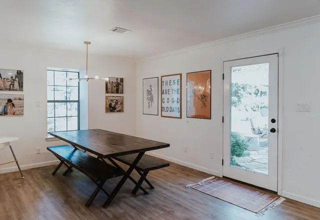 a bedroom with a bed wooden floor and window