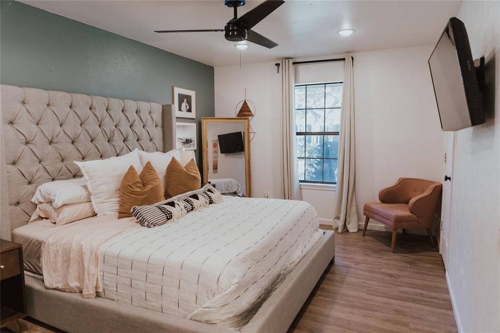312 Perkins Road Krugerville, TX 76227 - Photo 16 of 32 a bedroom with a bed wooden floor and window