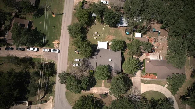 an aerial view of a house with yard