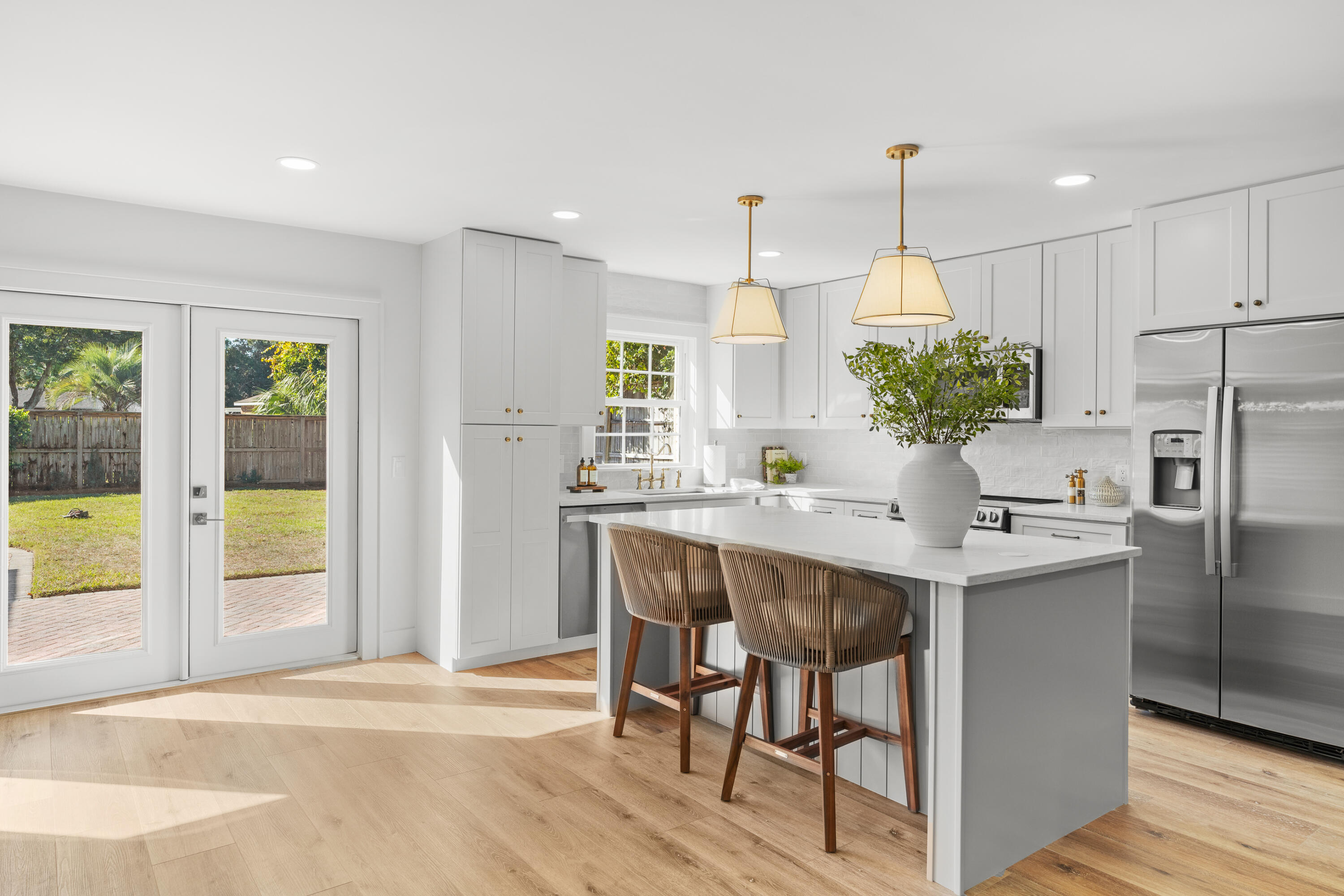 26 Sandestin Estates Drive Miramar Beach, FL 32550 - Photo 19 of 81 a kitchen with kitchen island a refrigerator a stove a sink and white cabinets with wooden floor