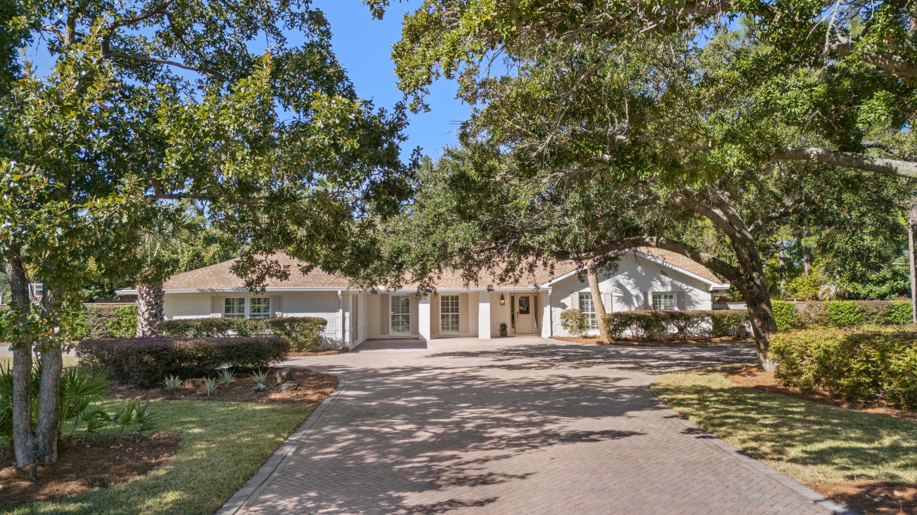 26 Sandestin Estates Drive Miramar Beach, FL 32550 - Photo 4 of 81 a front view of a house with a garden