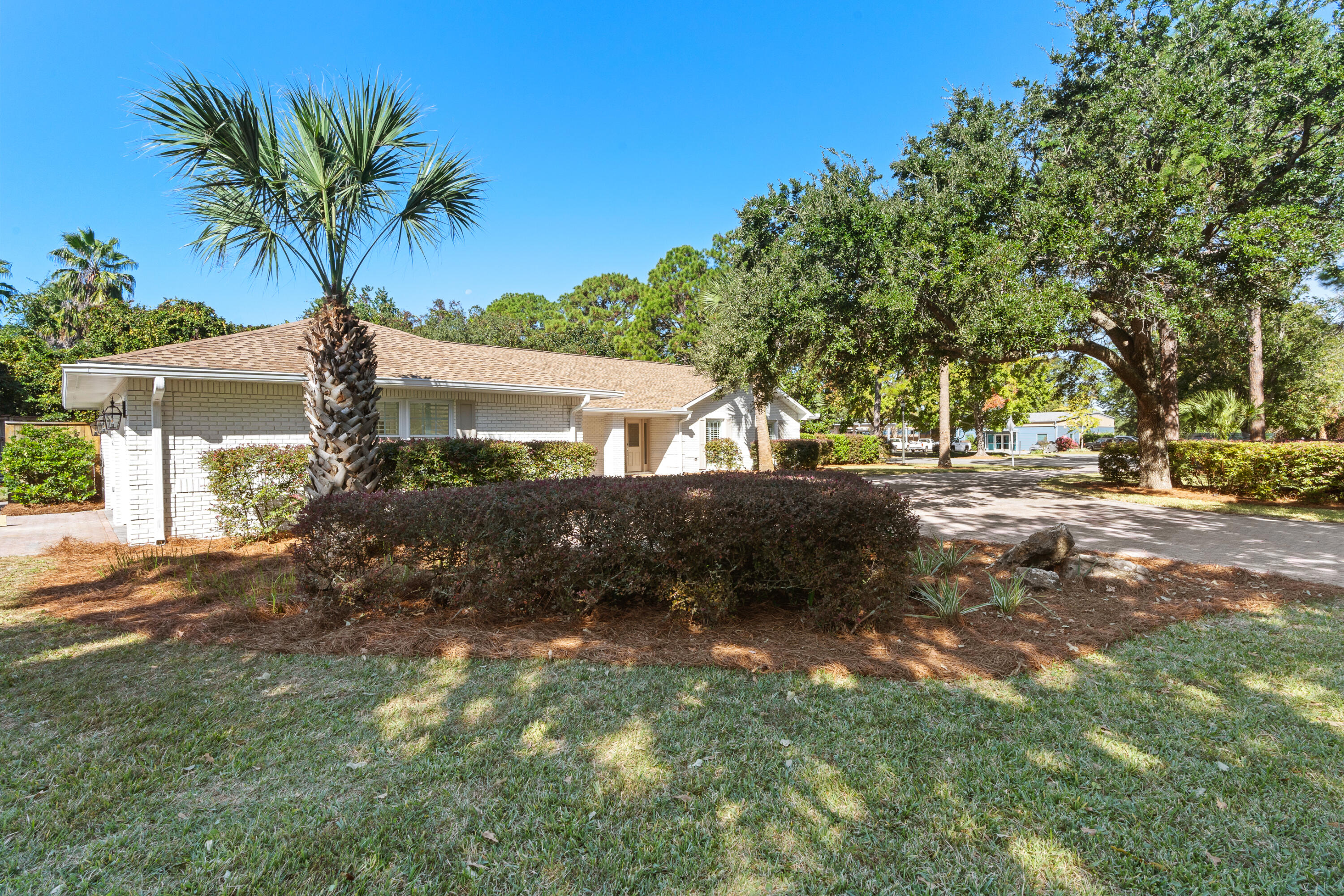 26 Sandestin Estates Drive Miramar Beach, FL 32550 - Photo 55 of 81 a front view of a house with a yard and garage