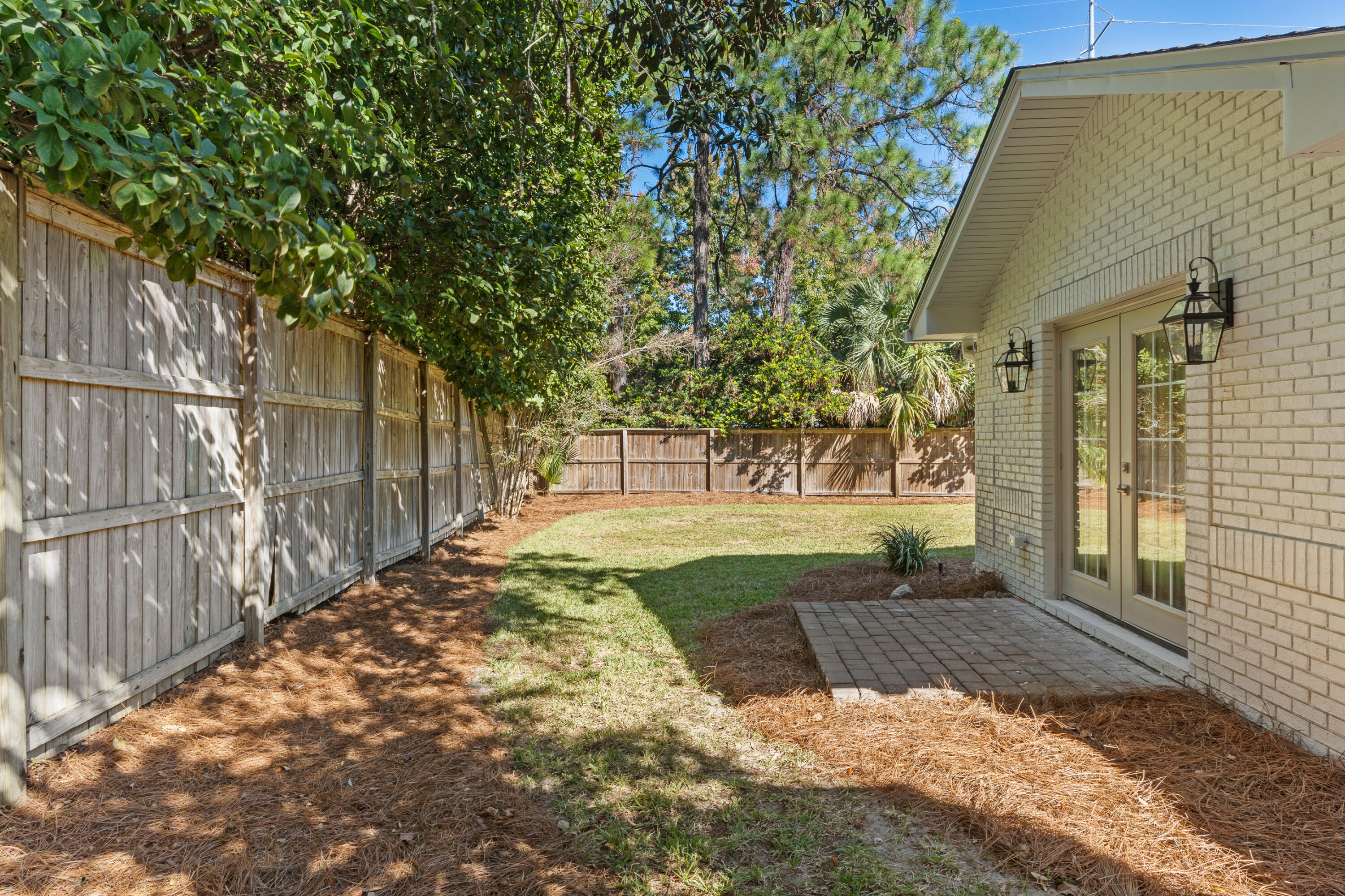 26 Sandestin Estates Drive Miramar Beach, FL 32550 - Photo 59 of 81 a view of backyard with large trees and wooden fence