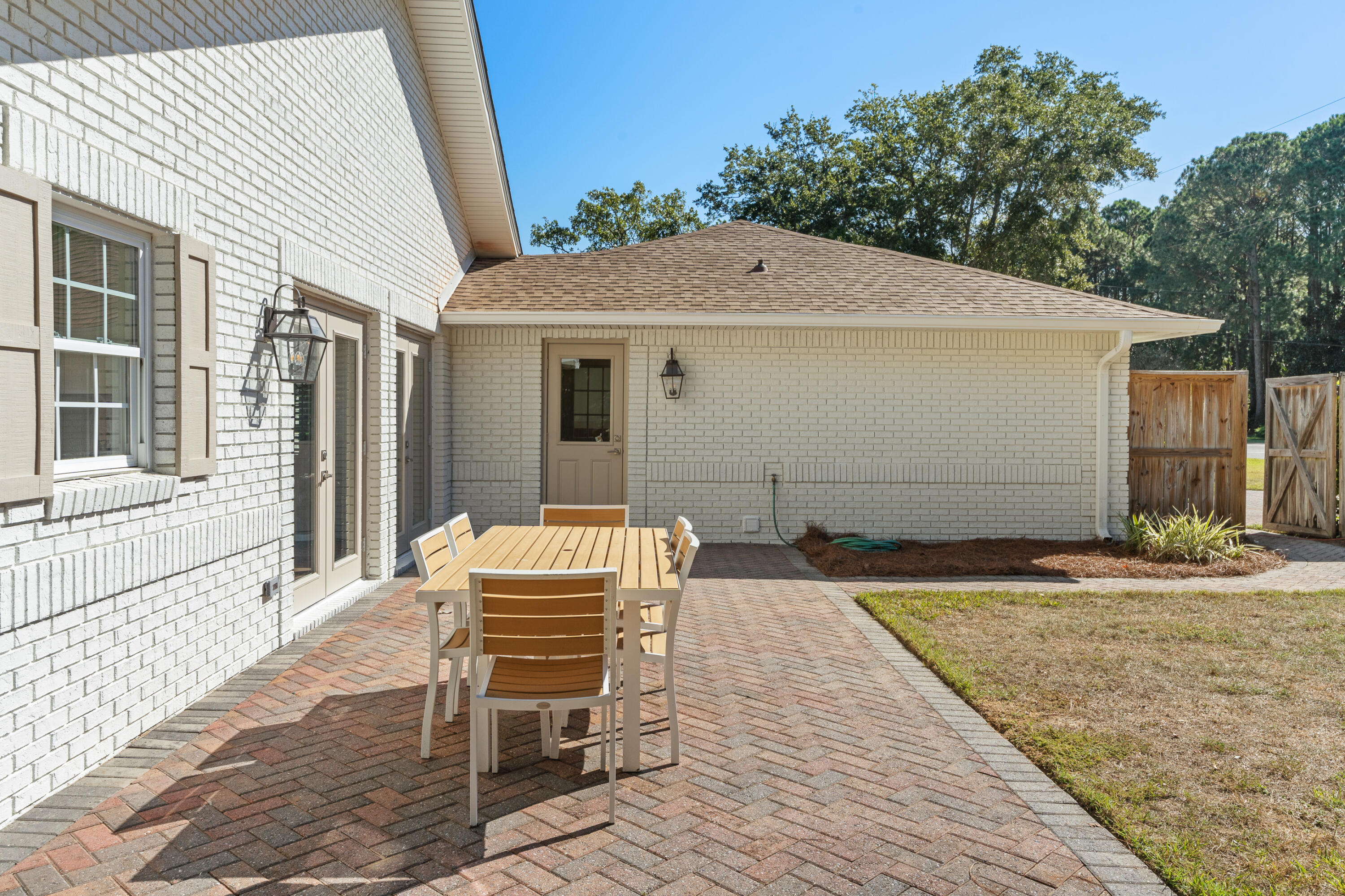 26 Sandestin Estates Drive Miramar Beach, FL 32550 - Photo 61 of 81 a backyard of a house with table and chairs