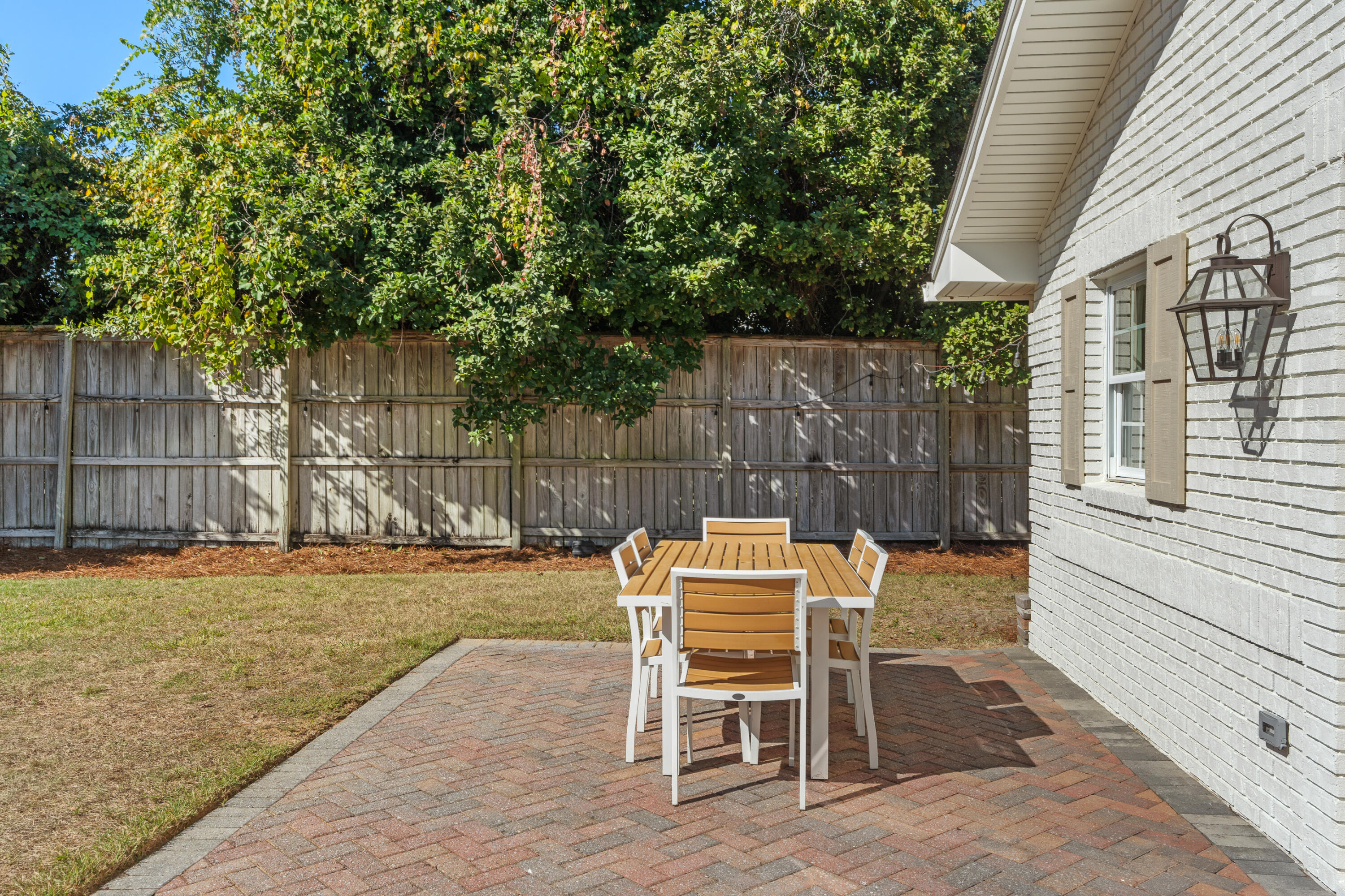 26 Sandestin Estates Drive Miramar Beach, FL 32550 - Photo 62 of 81 a patio with table and chairs and potted plants