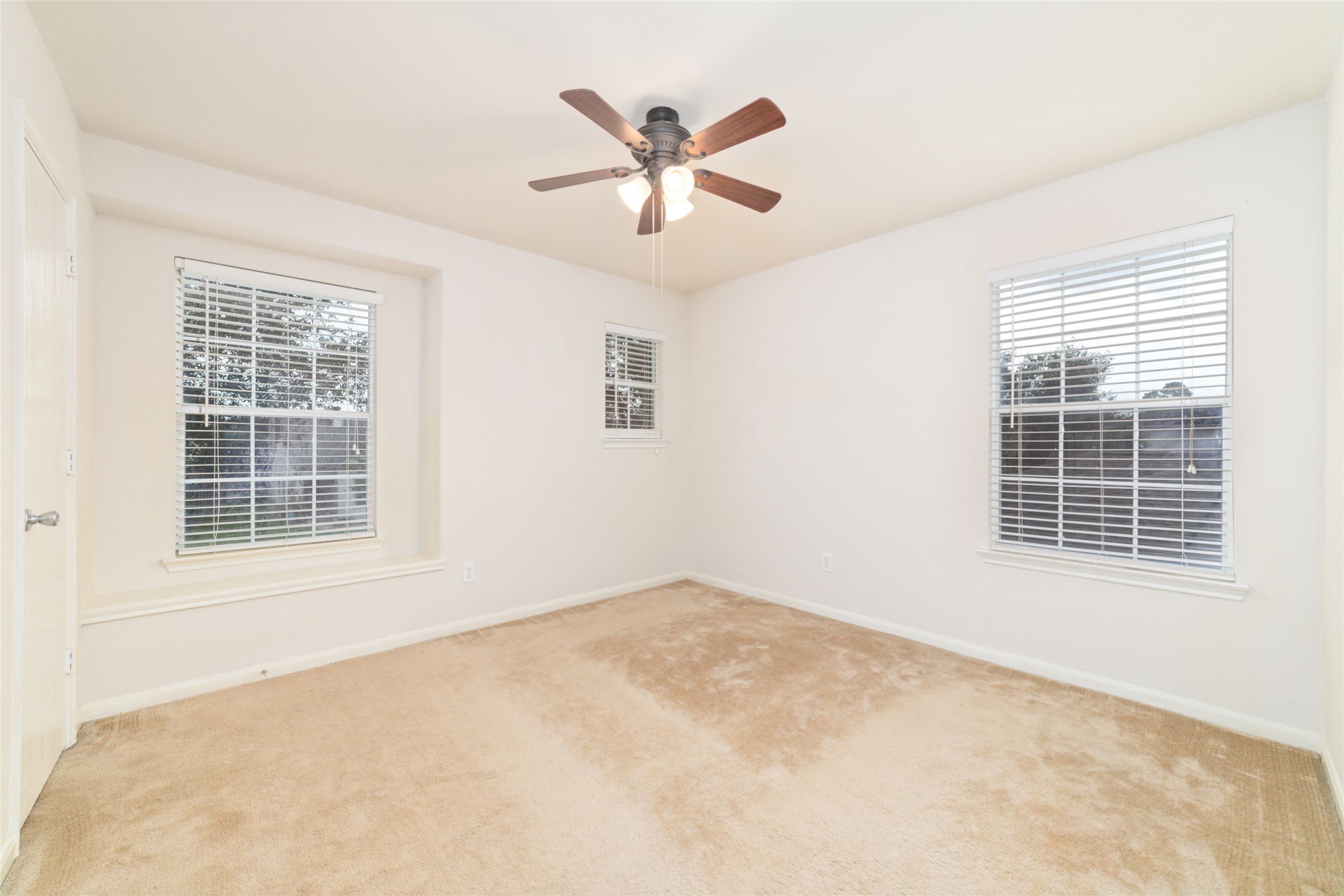 21311 Shadow River Lane Spring, TX 77379 - Photo 35 of 38 an empty room with ceiling fan and windows