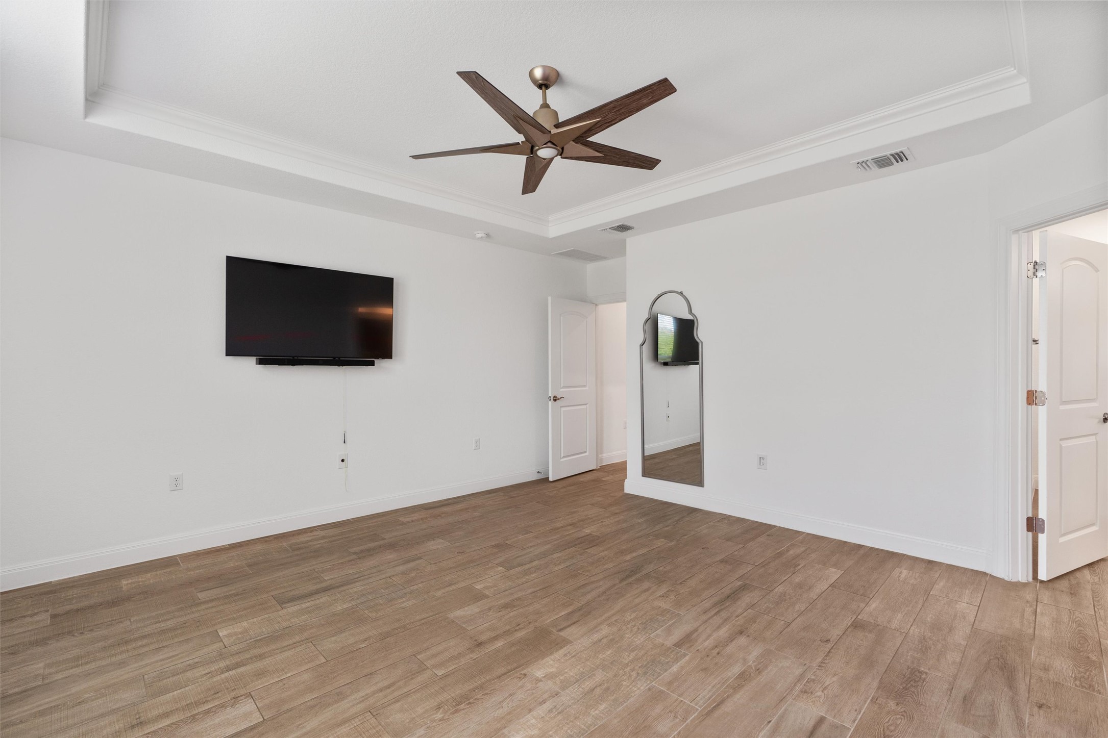 202 Spanish Star Street Georgetown, TX 78633 - Photo 18 of 32 an empty room with ceiling fan and wooden floor
