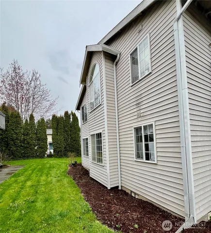 a view of a house with a yard and deck