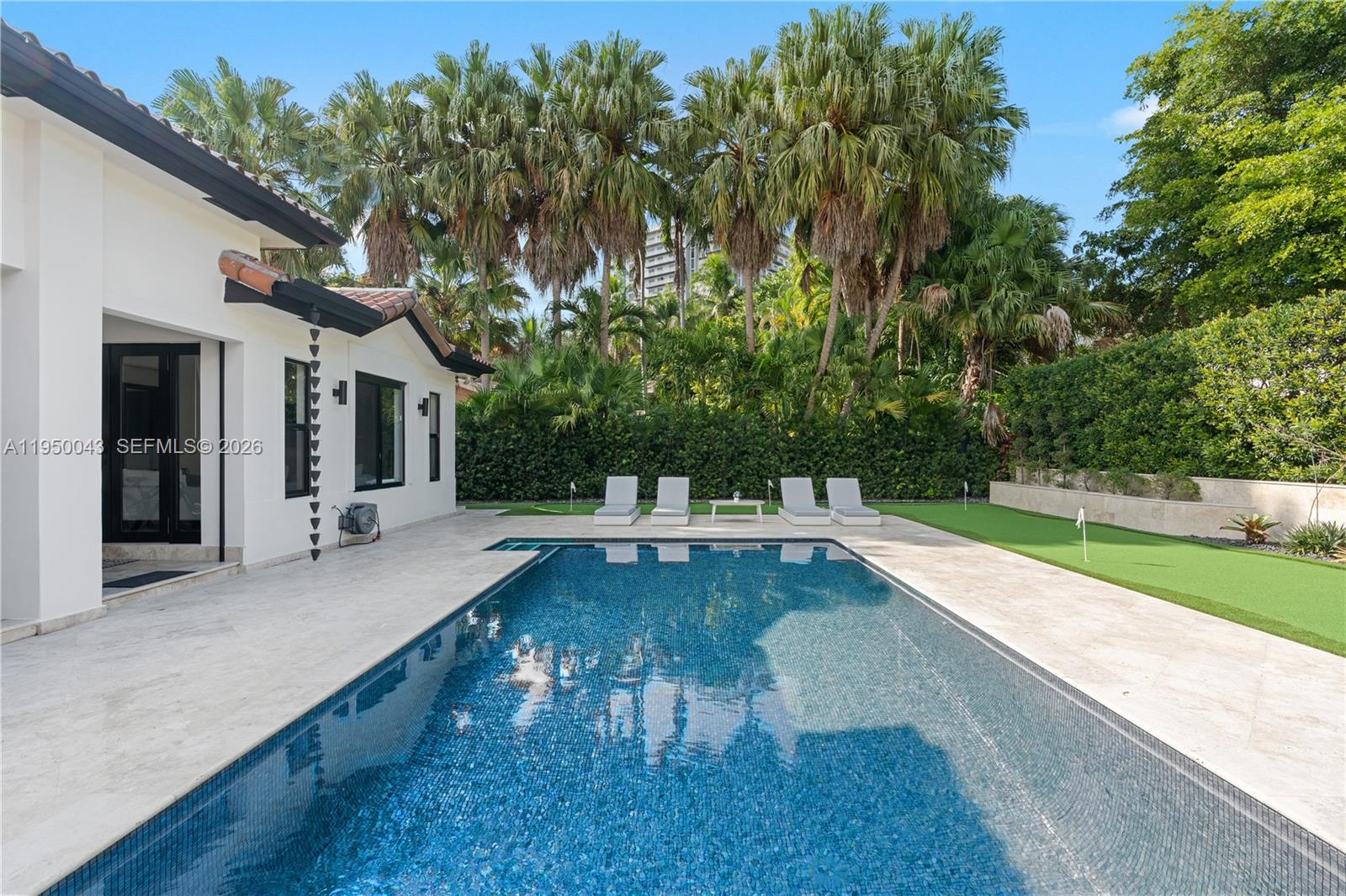 7345 Southwest 96th Street Pinecrest, FL 33156 - Photo 13 of 62 a view of a swimming pool with lounge chair