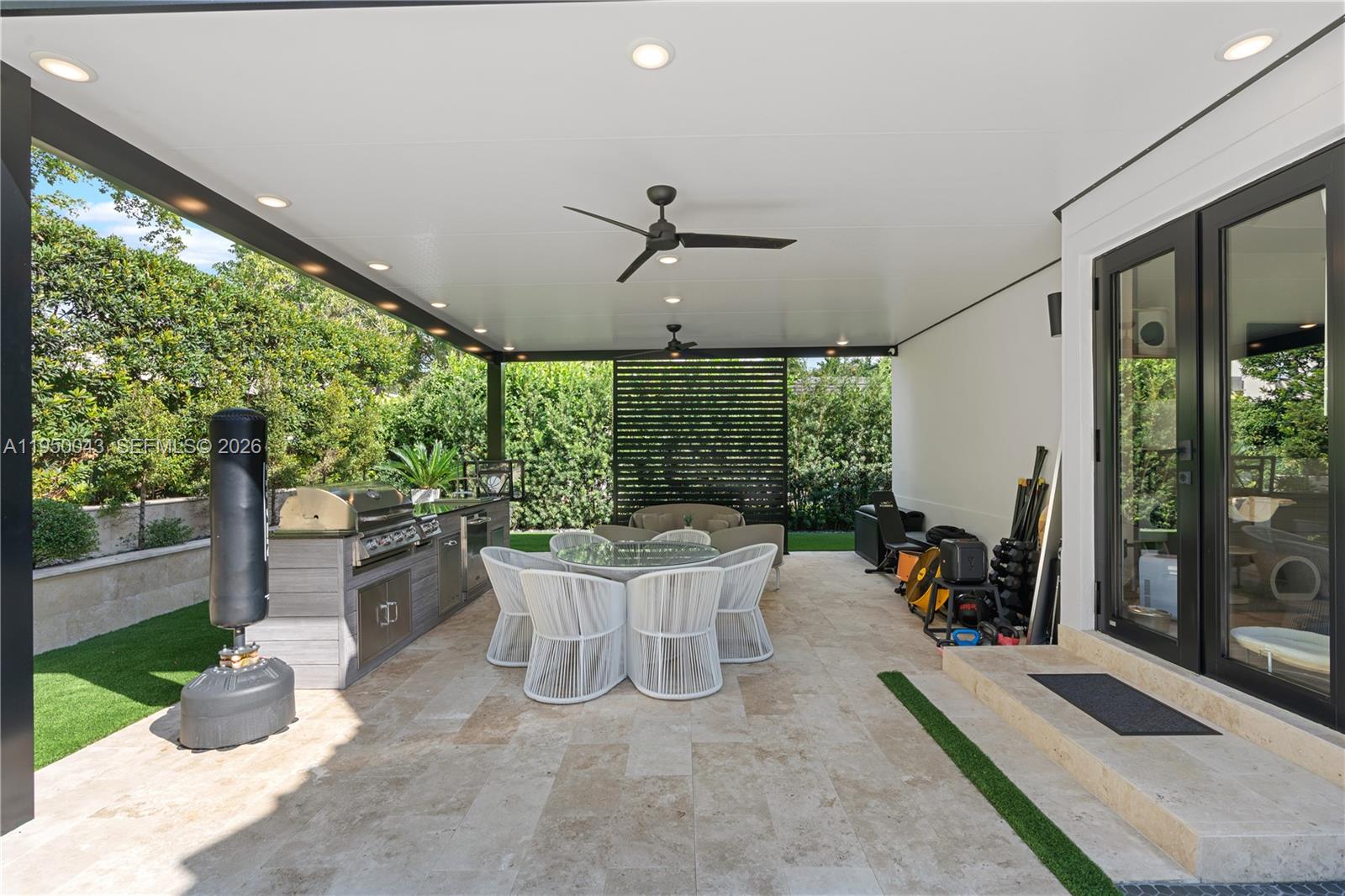 7345 Southwest 96th Street Pinecrest, FL 33156 - Photo 16 of 62 a view of a patio with a dining table and chairs