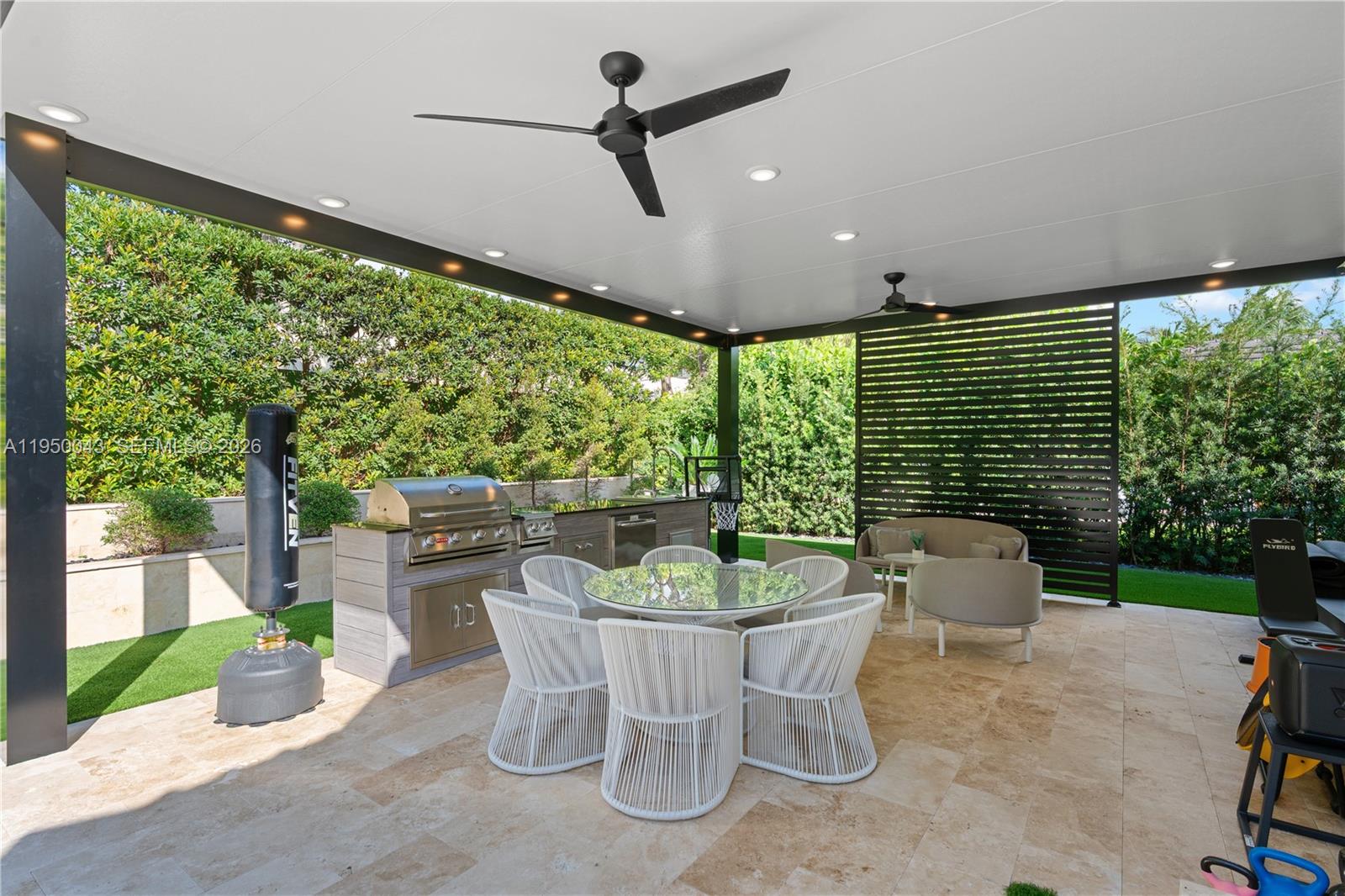 7345 Southwest 96th Street Pinecrest, FL 33156 - Photo 17 of 62 a dining room with furniture and garden view