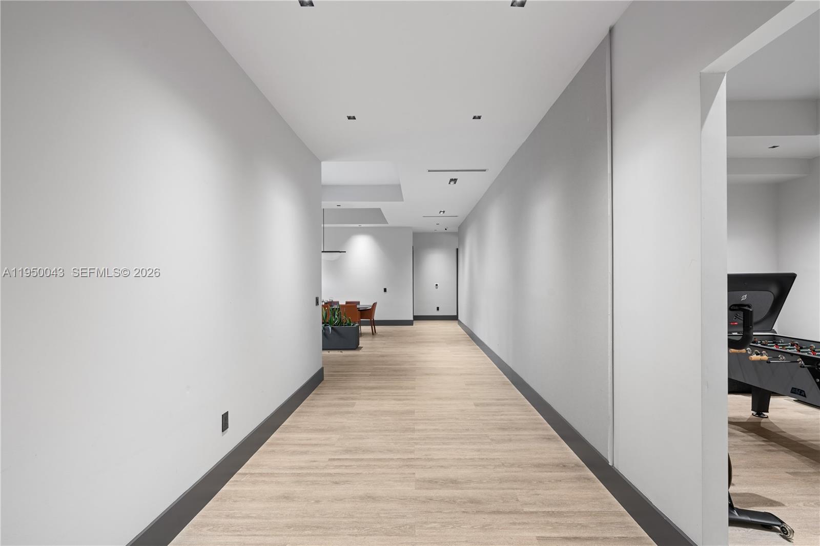 7345 Southwest 96th Street Pinecrest, FL 33156 - Photo 22 of 62 a view of a hallway with wooden floor and a living room