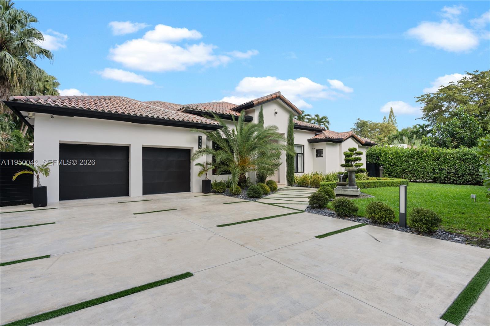 7345 Southwest 96th Street Pinecrest, FL 33156 - Photo 3 of 62 a front view of house with yard and trees around