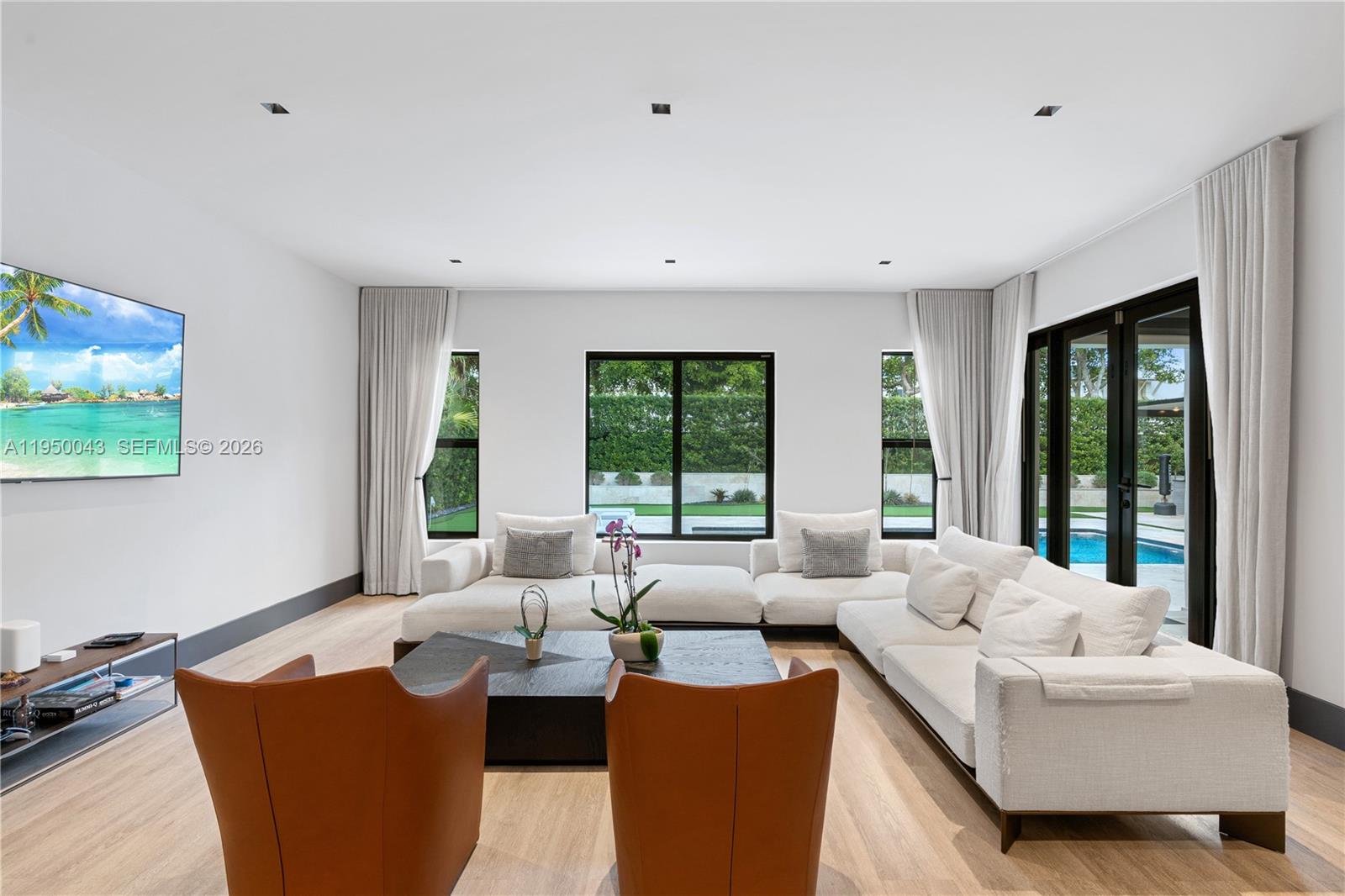 7345 Southwest 96th Street Pinecrest, FL 33156 - Photo 31 of 62 a living room with furniture and large windows