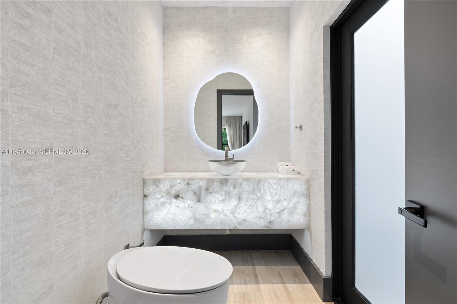 7345 Southwest 96th Street Pinecrest, FL 33156 - Photo 34 of 62 a bathroom with a toilet and a sink