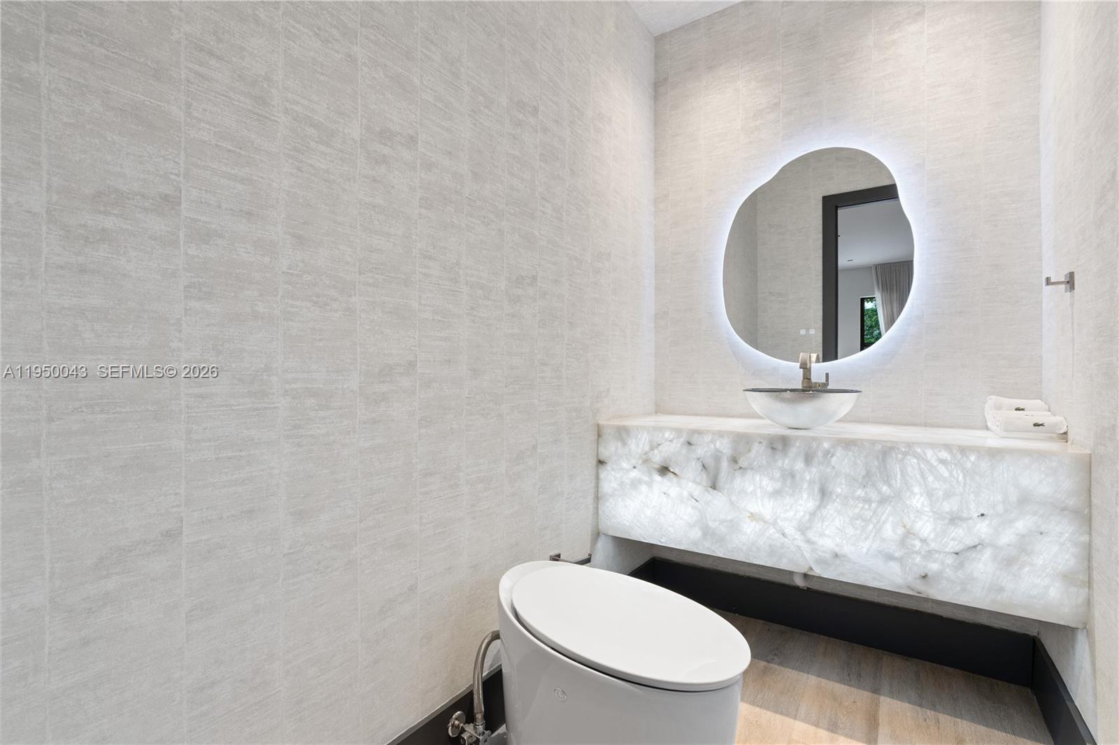 7345 Southwest 96th Street Pinecrest, FL 33156 - Photo 35 of 62 a bathroom with a toilet and a sink