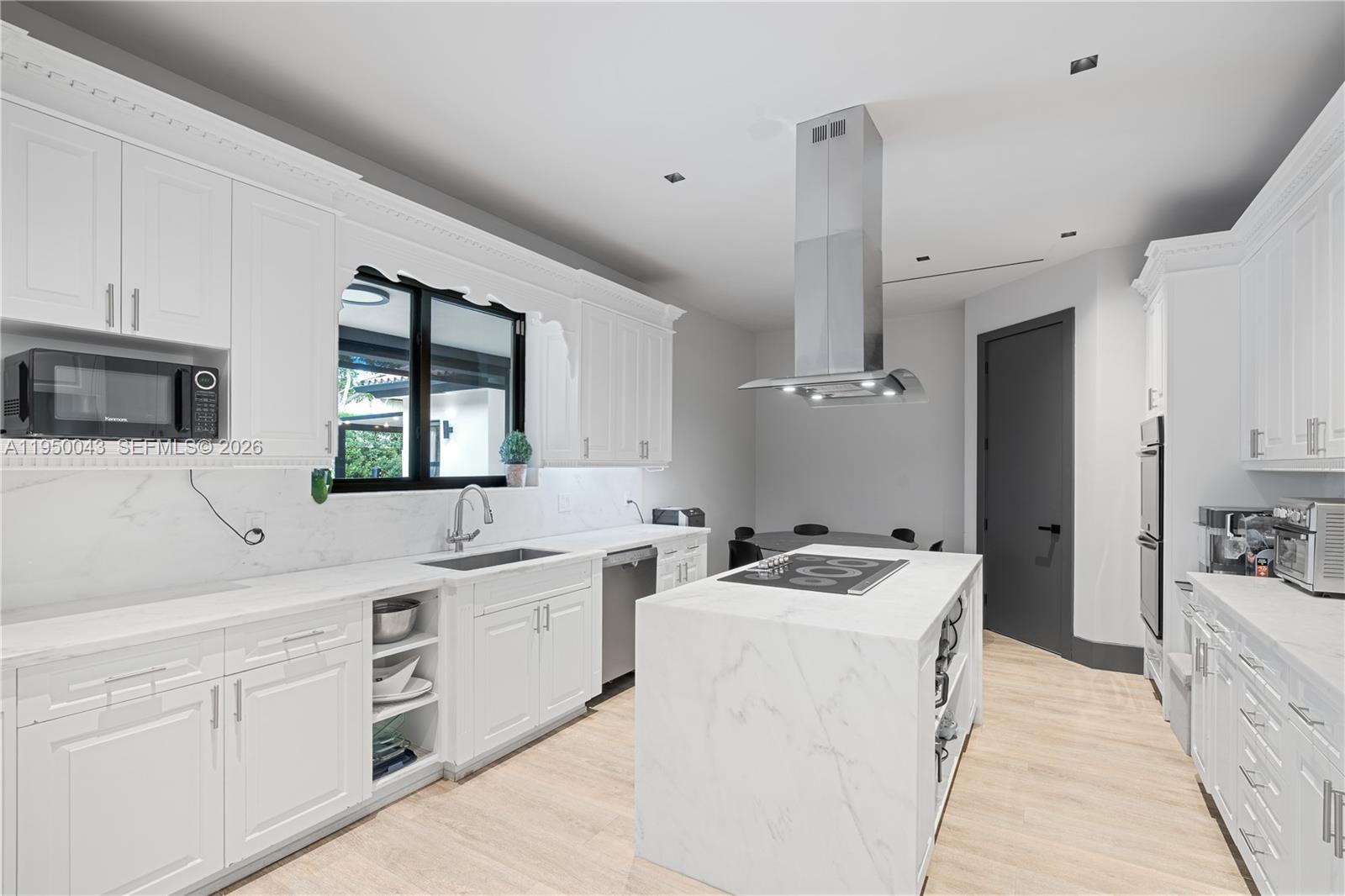 7345 Southwest 96th Street Pinecrest, FL 33156 - Photo 37 of 62 a kitchen that has a sink a stove and lots of wooden cabinets